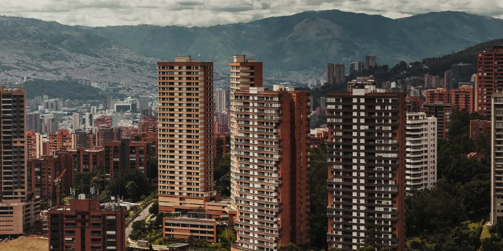 High-rises and tiled roofs in El Poblado, Medellín, against the mountains